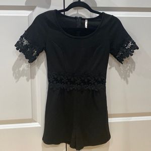 Black romper with knit mid section and sleeves